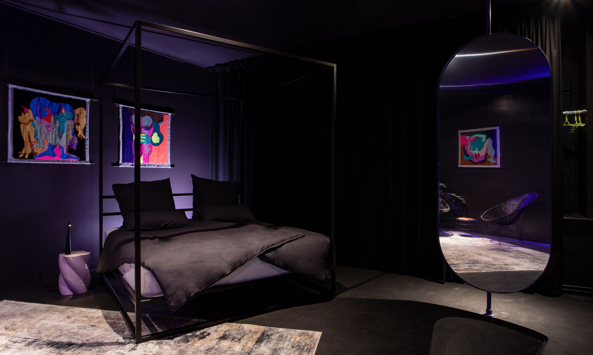 The custom-made, four-poster, kingsized bed in bedroom of The Circle Berlin, featuring artwork by Florencia Martina, is a great place for a design stay for two.