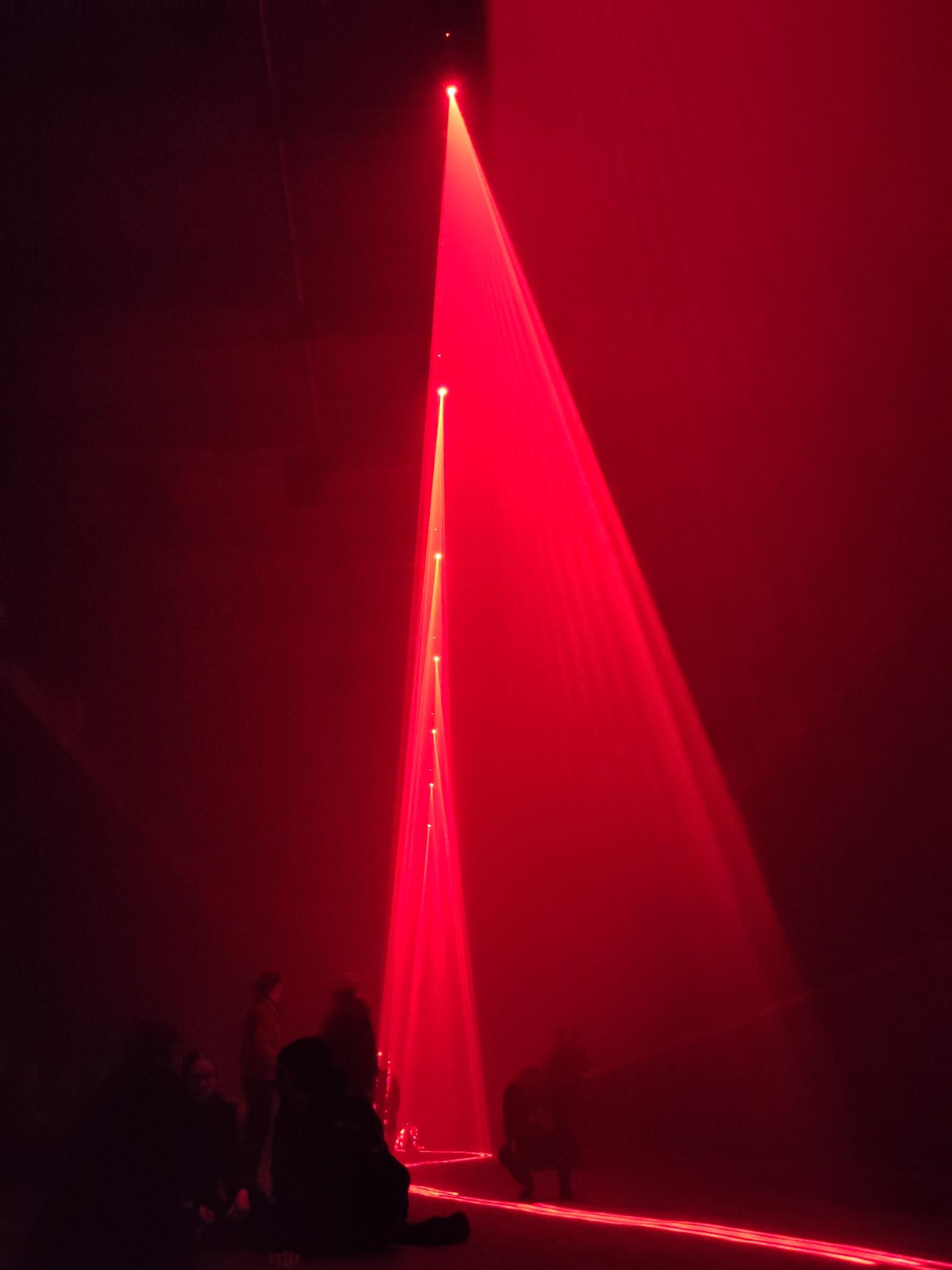 Vibrant red lights at Kraftwerk Berlin exhibition by Dark Matter artists, enhancing dramatic sensory experience.