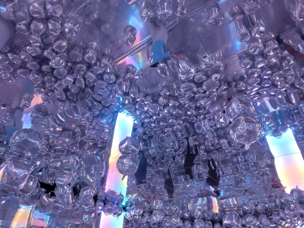 Silver balloons at the Ikonos exhibition in Berlin reflect the light creating a playful ambience.