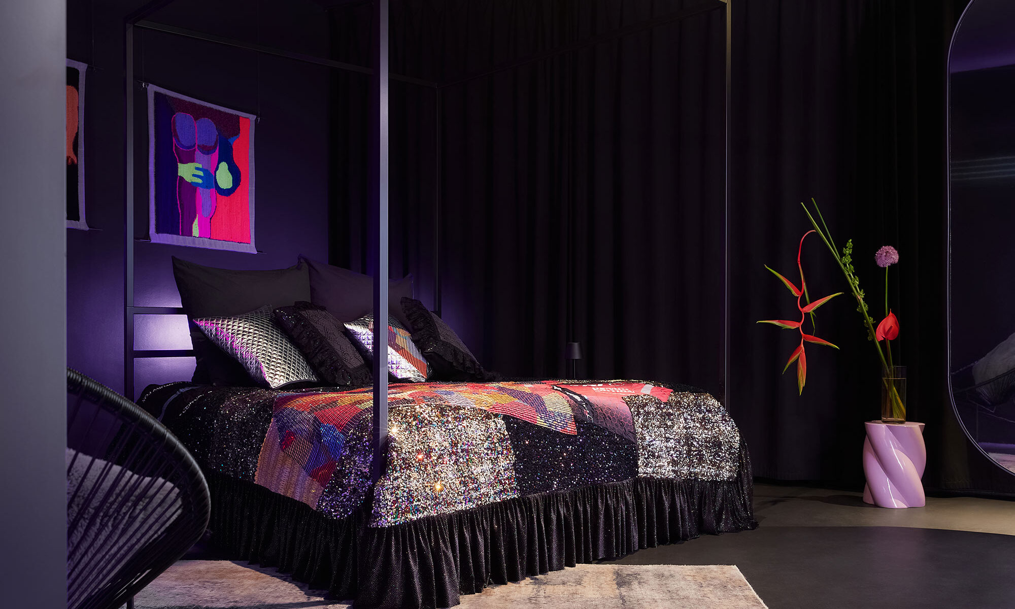 A custom-made kingsize 4-poster bed with a luxurious sequined bedspread by Tata Christiane, accented by giant designer flowers and premium artwork by Florencia Martina inside The Circle Berlin private spa suite.
